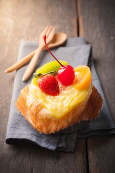Fruit danish pastry on wood table in morning time