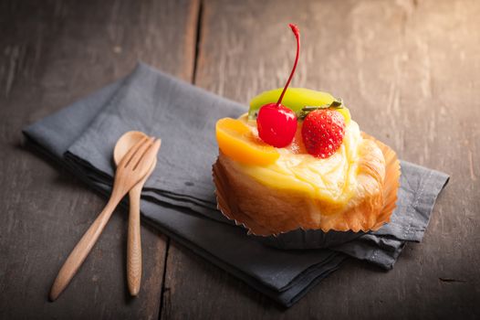 Fruit danish pastry on wood table in morning time