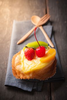 Fruit danish pastry on wood table in morning time