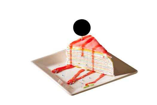Rainbow crepe cake with black label on top in afternoon low key scene