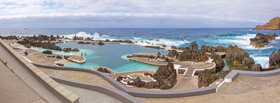 Porto Moniz, Portugal - June 2, 2013: Panorama of natural rock pool of Porto Moniz. It is a public bath with water from the Atlantic Ocean.