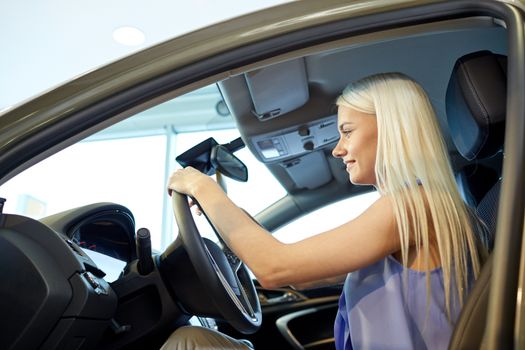 auto business, car sale, consumerism , transportation and people concept - happy woman sitting in or driving car