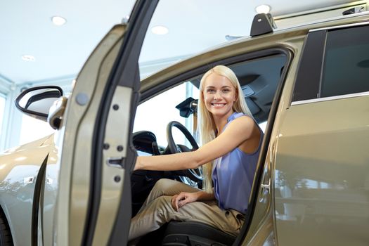 auto business, car sale, consumerism , transportation and people concept - happy woman sitting in or driving car