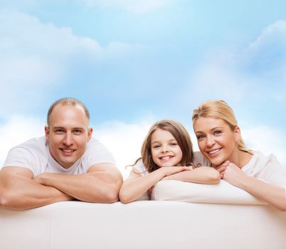 family, childhood and people - smiling mother, father and little girl over blue sky background