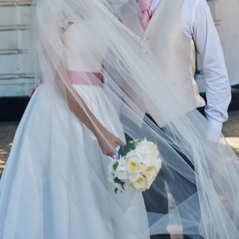 Elegant bride and groom posing together outdoors on a wedding day