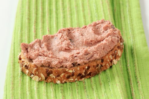 Slice of bread roll and liver pate