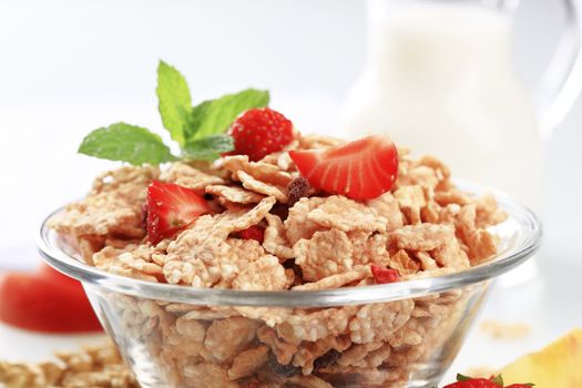 Bowl of breakfast cereal and fresh strawberries
