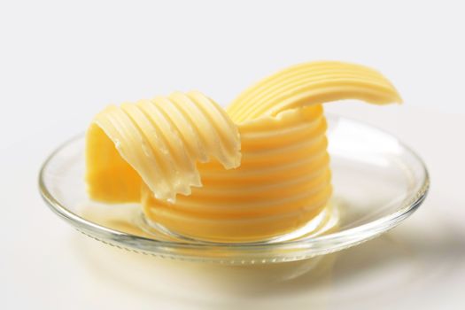 Butter curls on glass plate