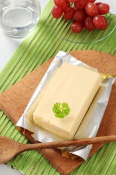 Block of fresh butter on a cutting board 