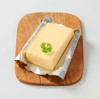 Block of fresh butter on a cutting board