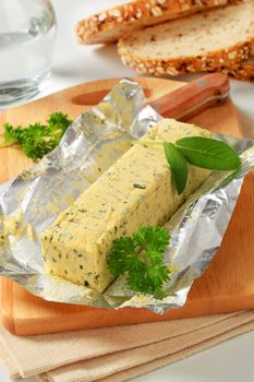 Stick of fresh herb butter and bread