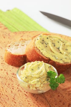 Bowl of herb butter and slices of bread