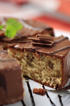 Delicious nut cake glazed with chocolate icing  