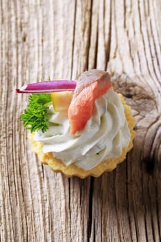 Tart pastry with spread and fish topping 