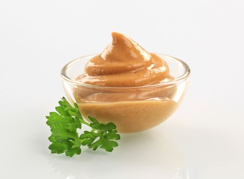 Swirl of spicy mustard in a bowl