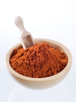 Ground red pepper in a wooden bowl