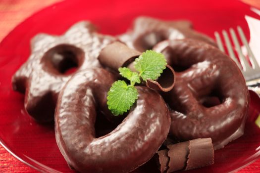 Chocolate covered gingerbread cookies on a red plate