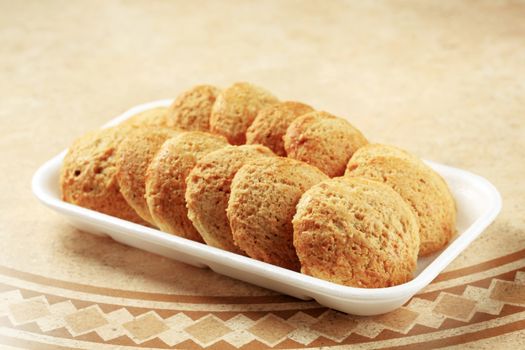 Rows of crispy cookies in styrofoam container