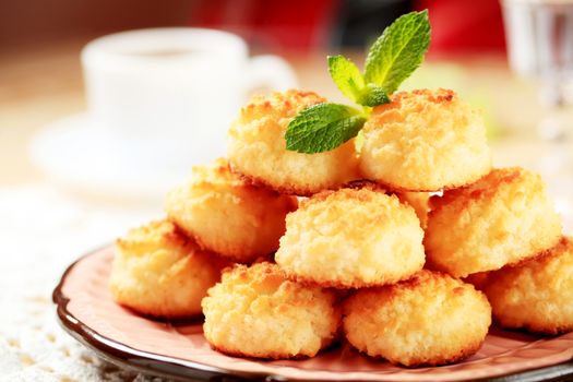 Stack of coconut macaroons on a decorative plate