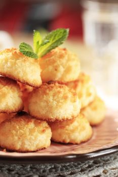 Stack of coconut macaroons on a decorative plate