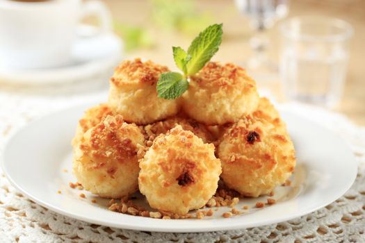 Coconut macaroons sprinkled with chopped nuts - closeup