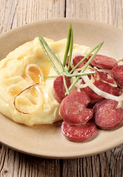 Mashed potato and slices of roasted sausage