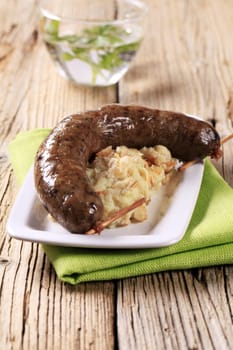 Roasted sausage served with barley mashed potato