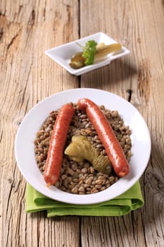 Cooked lentil with spicy sausages and pickles