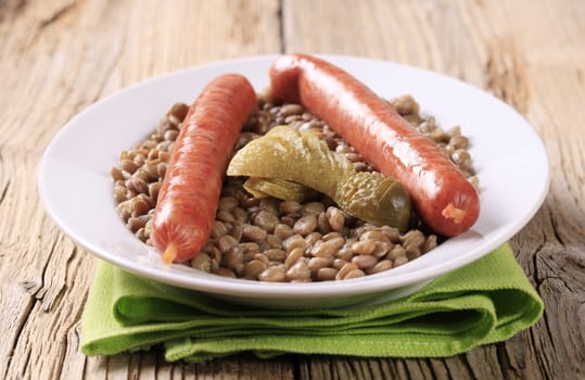 Cooked lentil with spicy sausages and pickles