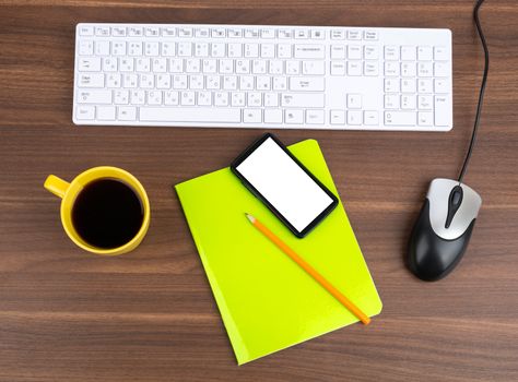 Keyboard with coffee and smartphone on wooden table 