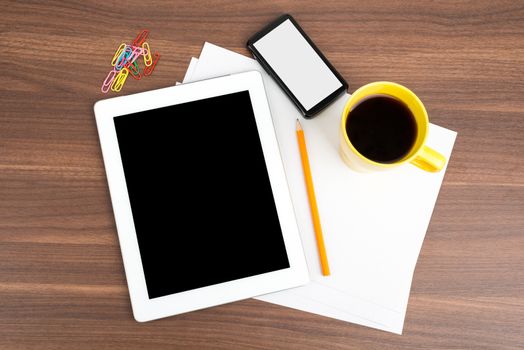 Tablet with blank paper and coffee on wooden table