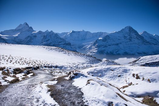 first mountain and the snow peaks of Jungfrau region grindelwald switzerland