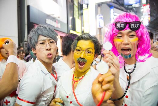 JAPAN, Tokyo : People wear costumes as they pose for pictures while taking part in a Halloween parade in Tokyo on October 31, 2015. Tens of thousands of people gathered at Tokyo's Shibuya fashion district to celebrate Halloween.