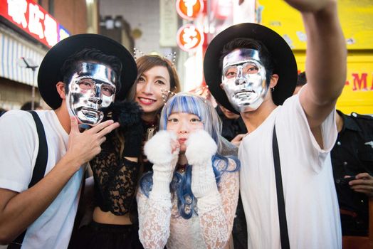 JAPAN, Tokyo : People wear costumes as they pose for pictures while taking part in a Halloween parade in Tokyo on October 31, 2015. Tens of thousands of people gathered at Tokyo's Shibuya fashion district to celebrate Halloween.