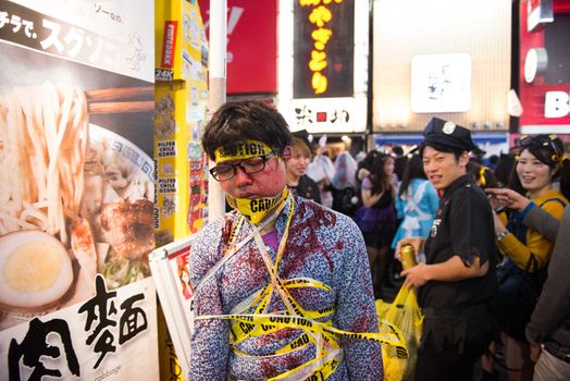 JAPAN, Tokyo : A man wears a costume as he poses for pictures while taking part in a Halloween parade in Tokyo on October 31, 2015. Tens of thousands of people gathered at Tokyo's Shibuya fashion district to celebrate Halloween.