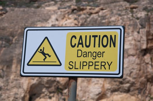 Sign indicating attention danger of slipping