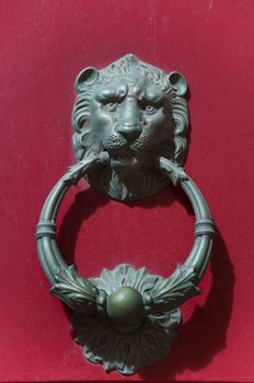 Detail of an old iron handle in the shape of lion