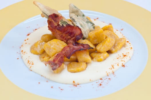 Gnocchi with pumpkin and peanut butter and crispy bacon,italy