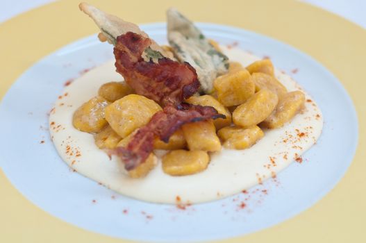 Gnocchi with pumpkin and peanut butter and crispy bacon,italy