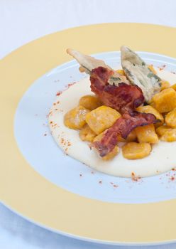 Gnocchi with pumpkin and peanut butter and crispy bacon,italy