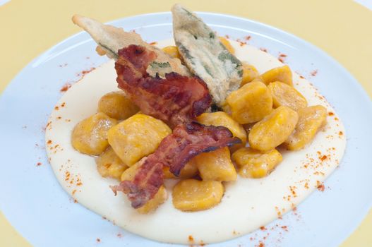 Gnocchi with pumpkin and peanut butter and crispy bacon,italy