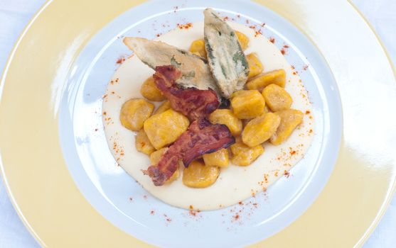 Gnocchi with pumpkin and peanut butter and crispy bacon,italy