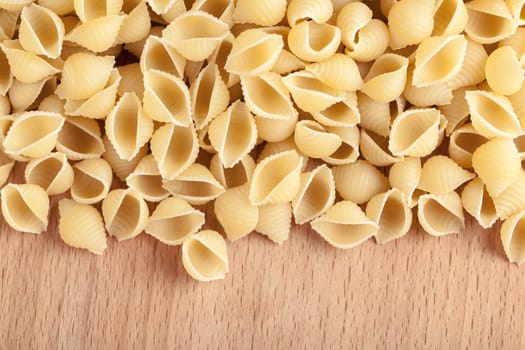 raw the pasta closeup on wooden background 