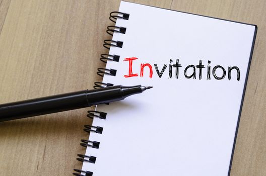 Invitation text concept write on notebook
