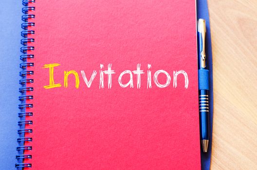 Invitation text concept write on notebook