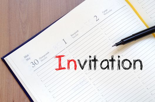 Invitation text concept write on notebook