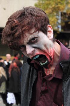 CANADA, Montreal: A man with fake blood in the face poses as he takes part in the Zombie Day of Montreal, on October 31, 2015.