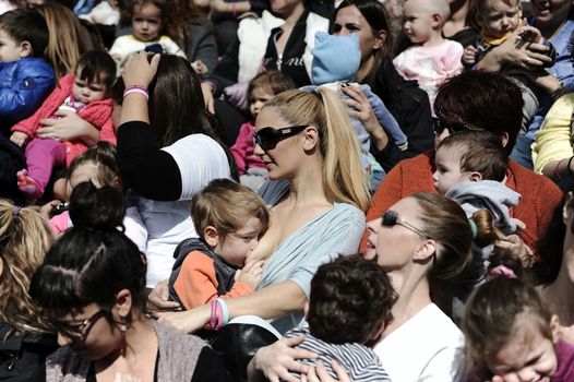 GREECE, Athens: A mother breastfeeds her baby during the 6th Panhellenic synchronized public breastfeeding festival, in Athens on November 1, 2015. The event takes place simultaneously in 50 cities of Greece.