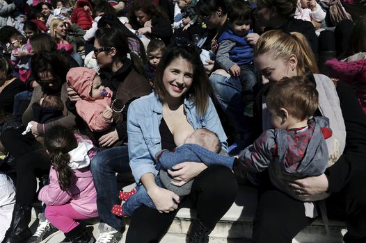 GREECE, Athens: A mother breastfeeds her baby during the 6th Panhellenic synchronized public breastfeeding festival, in Athens on November 1, 2015. The event takes place simultaneously in 50 cities of Greece.