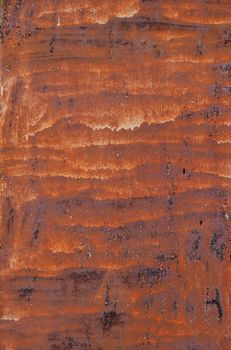 Bright rust stained corroded metal surface with uneven paint